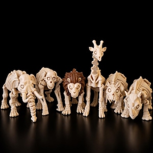 May include: A collection of animal skeleton figurines, including an elephant, monkey, lion, giraffe, and rhino. The figurines are off-white with brown accents on the lion's mane. The figures are arranged on a black surface.