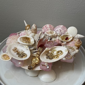 May include: A handmade wooden sign with the text "Welcome to our home" in a handwritten style. The sign is painted white with black lettering and a distressed finish, ideal for home decor.