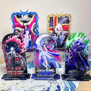 May include: Five decorative acrylic character standees featuring vibrant anime-style illustrations. The figures include Arlecchino, Columbina, and others, set against colorful, intricate backgrounds with ornate frames and bases labeled with names.
