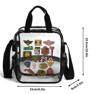 May include: A clear plastic tote bag with black trim and handles, featuring various colorful patches. The bag measures 10.0 inches in height, 8.3 inches in width, and 3.5 inches in depth. The patches include text like American Cars, Downfall, and 23.