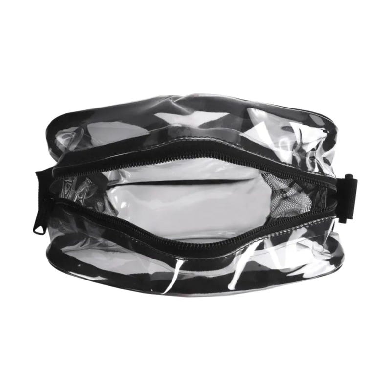 May include: A clear, transparent toiletry bag featuring black trim and a black zipper closure. The bag has a rectangular shape with rounded corners and a wide opening, revealing a hollow interior with a black mesh side pocket inside.