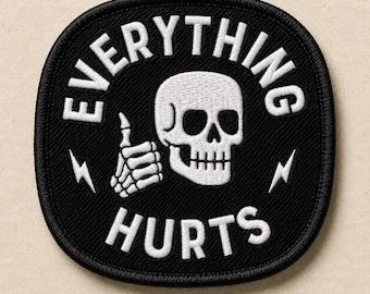 May include: A black embroidered patch with a white border, featuring a white skull giving a thumbs up. The text "EVERYTHING" is arched above the skull, and "HURTS" is below. Two small white lightning bolt icons flank the skull on each side.