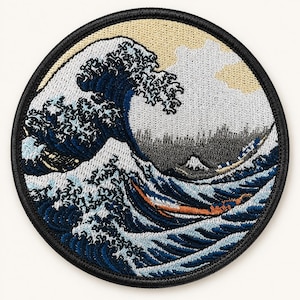 May include: A circular embroidered patch featuring a stylized ocean wave design in shades of dark blue, light blue, and white. The scene includes a pale yellow sky, white clouds, and a dark gray mountain peak, all bordered by a thick black stitched edge.