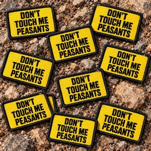 May include: A collection of rectangular embroidered patches with a yellow background and a black border. Each patch features the black text DON'T TOUCH ME PEASANTS in a bold, sans-serif font, arranged in three lines across the center.