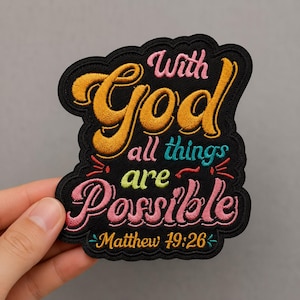May include: A black embroidered patch featuring the text "With God all things are Possible Matthew 19:26". The word "With" is pink, "God" is gold, "all things" is teal, "are" is lime green, and "Possible" is pink with gold lettering below.
