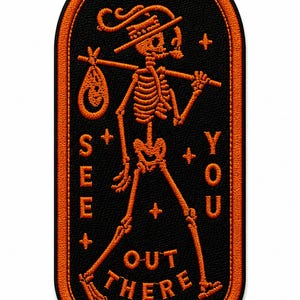 May include: An oval-shaped embroidered patch with a black background and orange border. It features an orange skeleton wearing a hat, carrying a bindle on a stick, and the text "SEE YOU OUT THERE" with small plus signs and stars.
