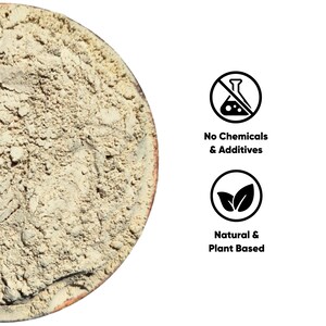 May include: Close-up of a light brown powder in a round container. The image includes text that reads "No Chemicals & Additives" and "Natural & Plant Based" in a black font with white background.