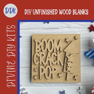 May include: Unfinished wood blank with the words "BOOM CRACK POP" and a firework design. The words and firework are cut out of the wood. The words "DIY UNFINISHED WOOD BLANKS" and "DIVINE DIY KITS" are also in the image.