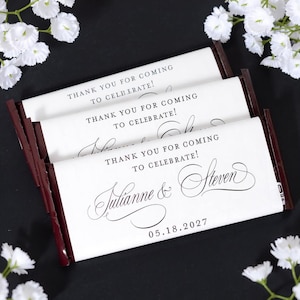 May include: Three chocolate bars with white wrappers, featuring the text "THANK YOU FOR COMING TO CELEBRATE!" and the names "Julianne & Steven" with the date "05.18.2027". The bars have dark brown edges.