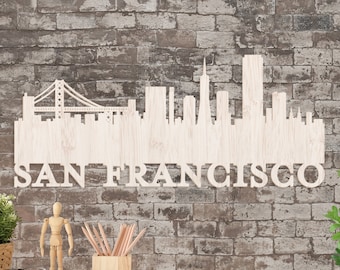 Könnte beinhalten: Weißer Holzschnitt der Skyline von San Francisco, einschließlich der Golden Gate Bridge, mit dem Text "SAN FRANCISCO" unter der Skyline.