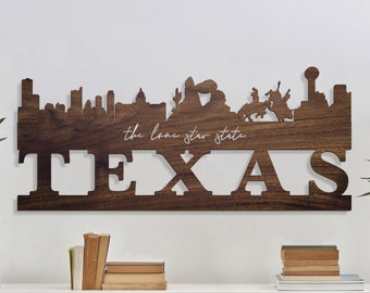 May include: A wooden wall decor featuring a silhouette of the Dallas skyline with the words "the lone star state" and "TEXAS" below.