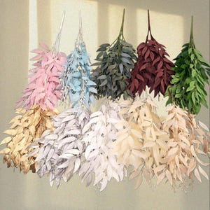 May include: A selection of artificial leaf stems in shades of pink, blue, green, and burgundy. The leaves vary in tone, offering a natural appearance. These faux stems are suitable for floral displays and interior decoration, adding a touch of nature.