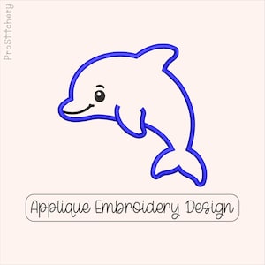 May include: An embroidery design featuring a white dolphin outline with a bold blue border. The dolphin has a black eye and a curved black mouth. Below the dolphin is a rectangular box containing the text Applique Embroidery Design.