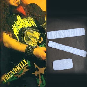 May include: Image features a person wearing a black t-shirt with a graphic design and the text "WASHHOUR". The person is also wearing a black studded wristband and camouflage pants with the text "TRENDKILL". Three white stickers with text are also visible.