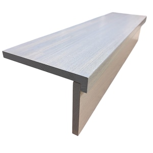 May include: A light grey wooden stair tread with a matching riser. The tread is rectangular with a slightly rounded edge. The wood grain is visible, and the finish is smooth. The stair tread is designed for indoor use.