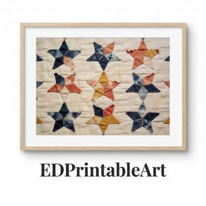 May include: A framed print featuring a close-up of a vintage quilt with star patterns. The stars are in shades of blue, orange, and yellow, set against a cream-colored background. The frame is a light wood color. The text "EDPrintableArt" is at the bottom.