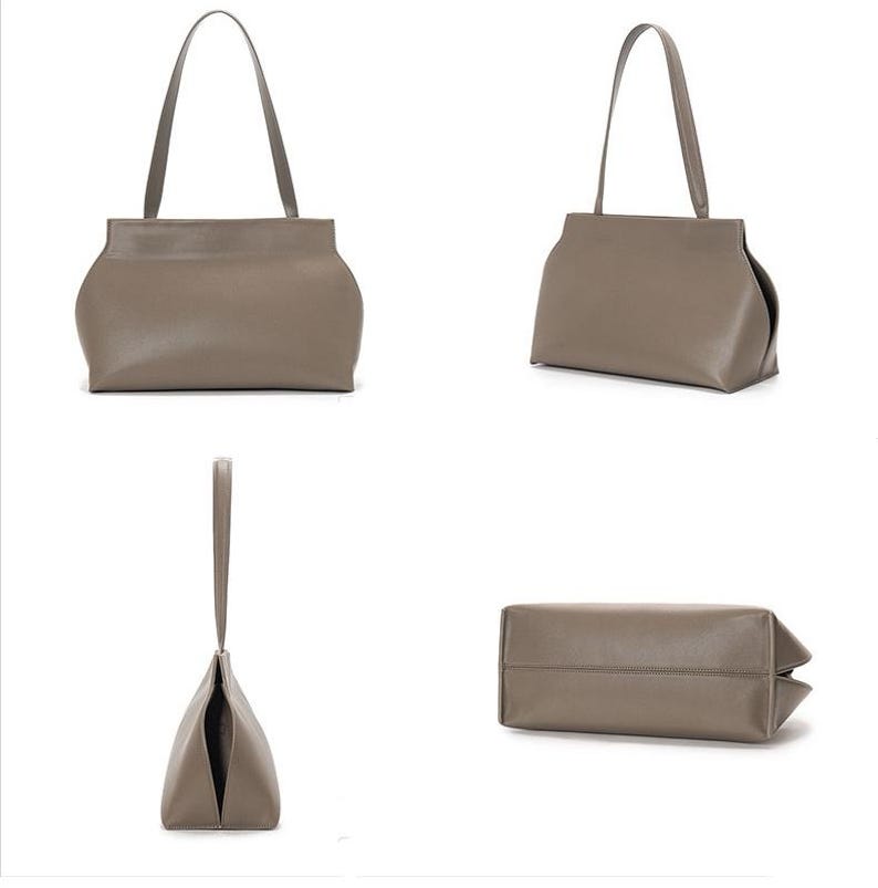 May include: A taupe-colored handbag with a rectangular base and curved sides. The bag has a single handle and is shown from multiple angles, including a front view, side view, and a view of the bottom.