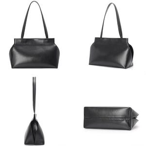 May include: A black leather tote bag with a rectangular body and curved sides. The bag has two long, thin handles and a structured design. The leather appears smooth and has a slight sheen. The bag is shown from multiple angles.