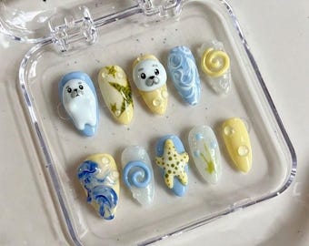Uñas postizas con diseño de estrella de mar y foca arpa, azul pastel y amarillo, con pegamento para el océano.