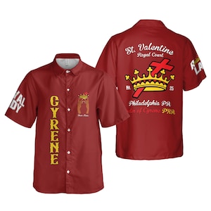 May include: A red short-sleeved button-down shirt featuring the text CYRENE vertically on the front. The back displays a crown, a red cross, and the text St. Valentine Royal Court, Philadelphia PA, Order of Cyrene PHA. The sleeves feature the text ROYAL LADY.