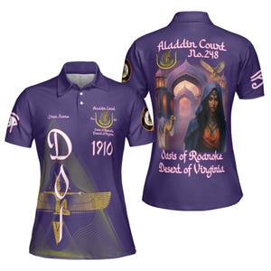 May include: Purple polo shirt featuring the text "Aladdin Court No.248" and "Oasis of Roanoke Desert of Virginia." The shirt has a graphic of a woman, camel, and eagle. The front has the text "Your Name", "D", and "1910".