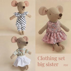 May include: Three beige fabric mouse dolls with large ears and brown noses. One wears a white top and trousers with black hearts, one wears a pink floral dress, and one wears a floral top with a white skirt. Text reads: Clothing set big sister PDF.