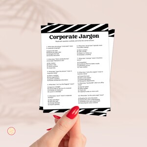May include: A stack of white paper sheets with the title "Corporate Jargon" printed in black. The text includes multiple-choice questions about business slang. The paper is held by a person with red nail varnish.