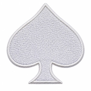May include: A white embroidered patch in the shape of a spade playing card suit. The patch features a dense, textured thread pattern throughout the spade symbol and is finished with a clean, stitched border that outlines the entire shape.