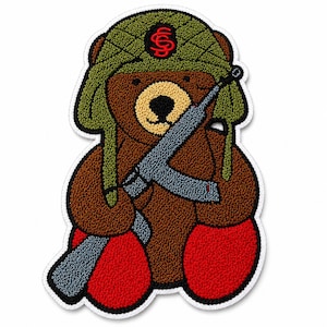 May include: Embroidered patch of a brown teddy bear wearing a green military-style hat with a red emblem and holding a grey rifle. The bear has red feet and a white border.