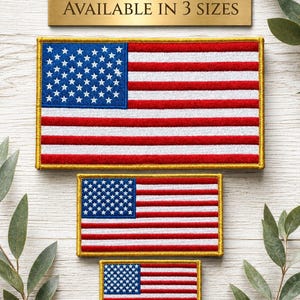 May include: Embroidered American flag patches in three sizes. The patches feature a blue canton with white stars and red and white stripes. The patches are framed with a gold border. The text "AVAILABLE IN 3 SIZES" is above the patches.