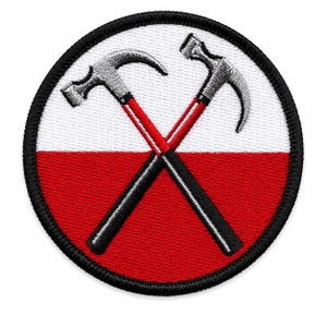 May include: A circular embroidered patch featuring a background split horizontally into white and red sections. Two grey hammers with red and black handles are crossed in the center. The entire design is bordered by a thick black stitched edge.