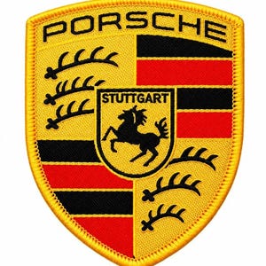 May include: A shield-shaped embroidered patch featuring the Porsche logo in black text at the top. The design includes a yellow background with black and red horizontal stripes, black antlers, and a central crest with a black horse and the word STUTTGART.
