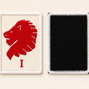 May include: Two rectangular embroidered patches. The left patch is off-white with a red lion head profile and the red Roman numeral I below it, featuring a white stitched border. The right patch is solid black with a white stitched border.