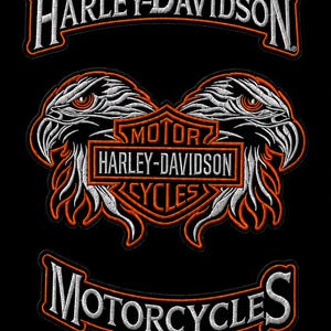 May include: Embroidered Harley-Davidson patch featuring two eagle heads facing each other, with the Harley-Davidson logo and the words "MOTORCYCLES" and "CYCLES" in white and orange. The patch is on a black background.