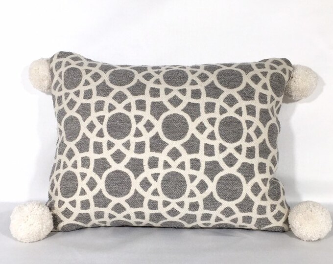 Geometric pillow cover with pompoms