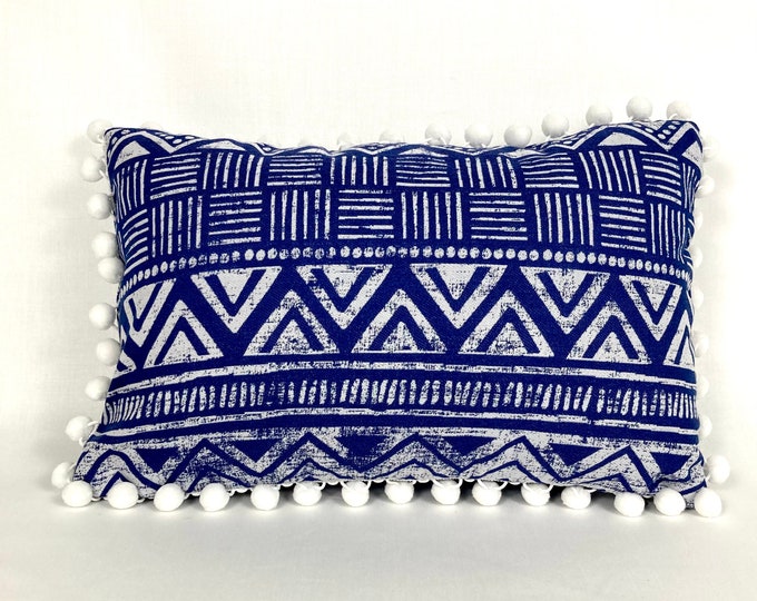 Blue and white lumbar pillow cover with pompoms