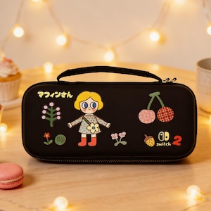 May include: Black Nintendo Switch carrying case with a cartoon girl and fruit graphics. The case has a handle and a zipper closure. The design includes cherries, a strawberry, and the text "Switch 2".
