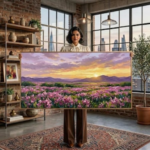May include: A large rectangular landscape painting featuring a vibrant field of pink flowers in the foreground, rolling purple mountains in the distance, and a sunset sky with hues of orange, yellow, and soft lavender clouds above the horizon.