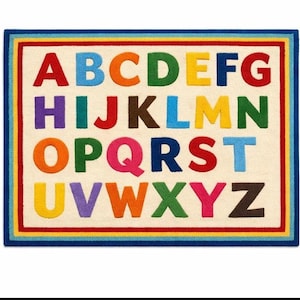 May include: A rectangular rug with the alphabet in uppercase letters. Each letter is a different color, including red, orange, yellow, green, blue, purple, and brown. The rug has a cream-colored background with a multi-colored border.