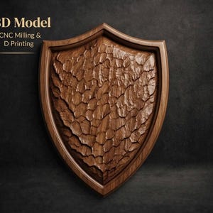 May include: A wooden shield with a textured surface, featuring a detailed carved design. The shield is a medium brown color and has a dark brown border. The text "3D Model For CNC Milling & D Printing" is visible in the upper left corner.