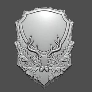 May include: A silver-colored, shield-shaped plaque with a blank center for customization. The plaque features a detailed relief of deer antlers, oak leaves, and acorns, set against a textured, wood-like background. Ideal for hunting or nature-themed decor.