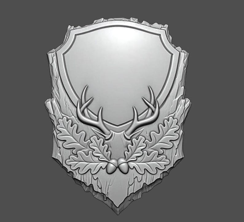 May include: A silver-colored, shield-shaped plaque with a blank center for customization. The plaque features a detailed relief of deer antlers, oak leaves, and acorns, set against a textured, wood-like background. Ideal for hunting or nature-themed decor.
