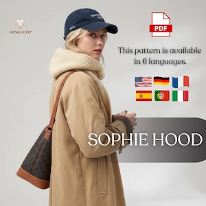 Puede incluir: Una mujer con una gorra de béisbol azul marino, un abrigo color canela y una bufanda beige. La imagen incluye el texto "SOPHIE HOOD" y "This pattern is available in 6 languages."
