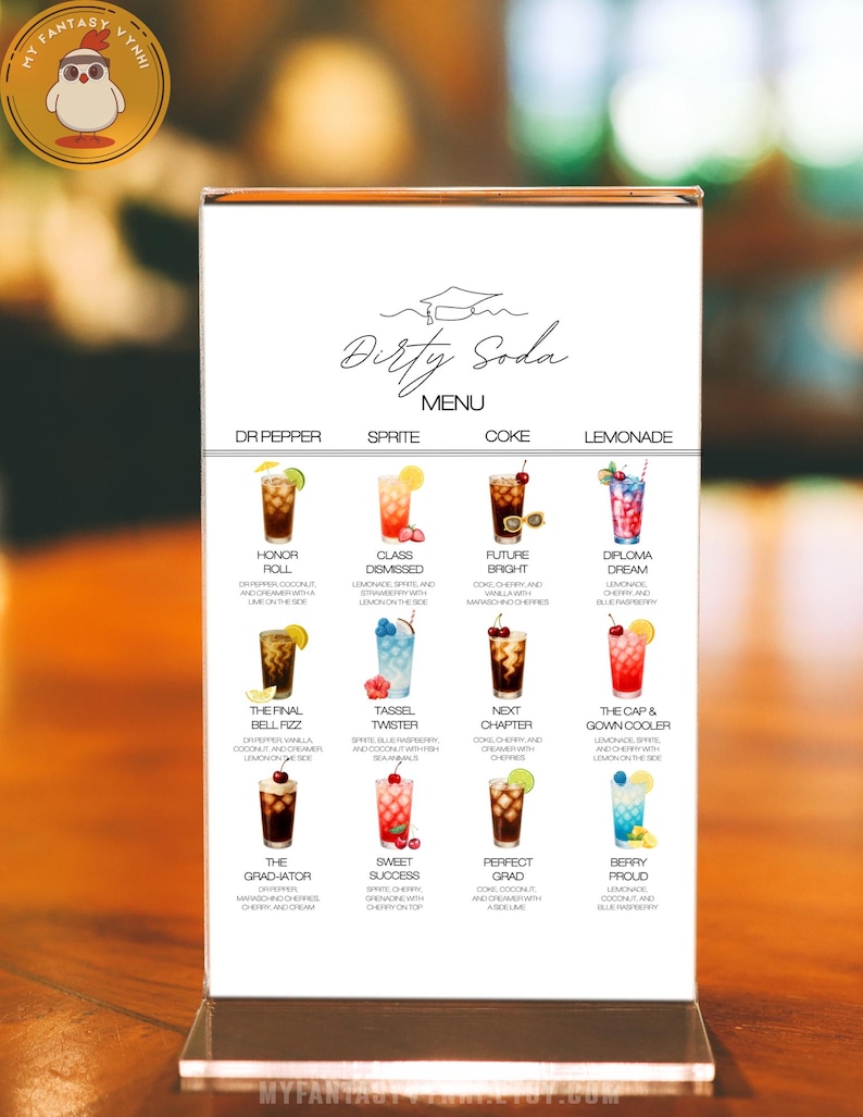 May include: A clear acrylic menu stand displaying a "Dirty Soda" menu with various colorful drink illustrations. The menu features drink names like "Honor Roll" and "Diploma Dream" with ingredient descriptions. The stand is on a wooden surface.