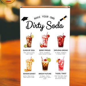 May include: A clear acrylic sign displays six colorful soda recipes with names like "Class of 2026" and "Berry Proud." The sign reads "Make Your Own Dirty Soda" in a stylish font. Each drink is garnished with fruit and served in a tall glass.