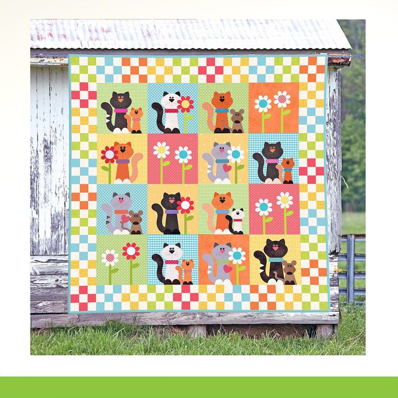 May include: A square quilt featuring a grid of sixteen panels decorated with colorful cats, small mice, and flowers. The quilt is framed by a border of small, alternating orange, yellow, red, and light blue squares in a checkerboard pattern.