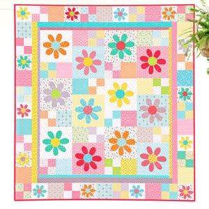 May include: A patchwork quilt featuring a grid of squares in various pastel colours and patterns, including pink, blue, yellow, and green. The quilt is decorated with multiple large, colourful fabric flower appliqués in shades of red, orange, yellow, and teal.