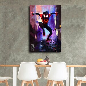 May include: A canvas print featuring a dynamic illustration of a superhero in a black and red suit, leaping through a city scene. The artwork has a vibrant color palette of purple, red, and yellow, with a signature in the lower left corner.