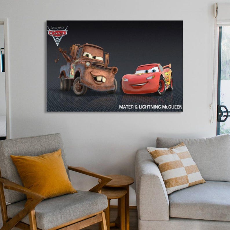 May include: A framed canvas print featuring the Disney Pixar Cars characters, Mater and Lightning McQueen, against a dark background. The print includes the Disney Pixar Cars logo and the text "Mater & Lightning McQueen".