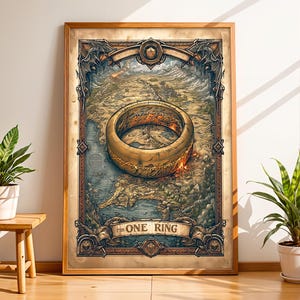 May include: A rectangular framed wall art print featuring a detailed map of a fantasy landscape with a large, glowing gold ring centered in the middle. The text THE ONE RING is printed on a banner at the bottom of the illustration in dark lettering.